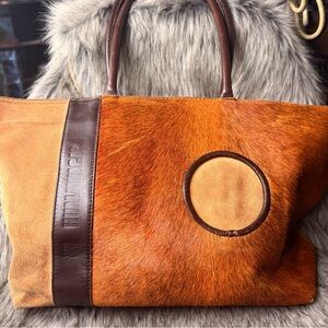 This is a Humawaca calfskin travel bag with hair